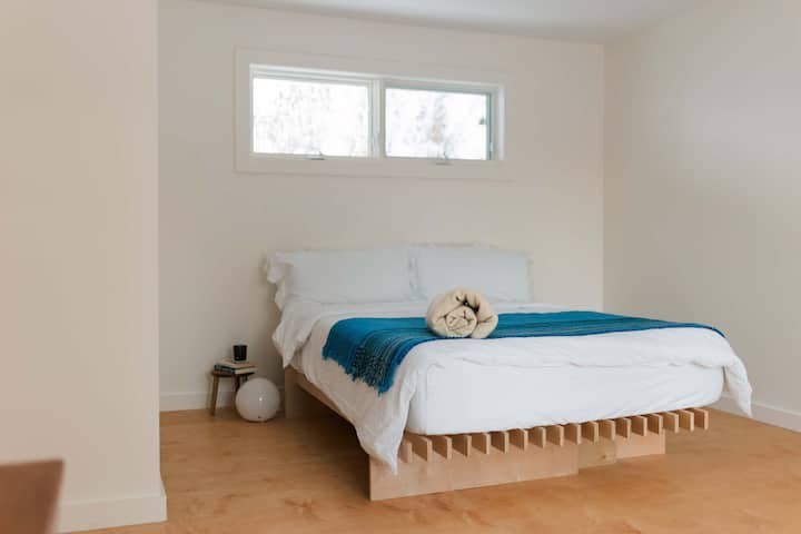 The primary bedroom is very spacious with a queen sized bed + double walkout patio doors.
