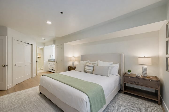 Serene primary bedroom featuring a luxurious king bed