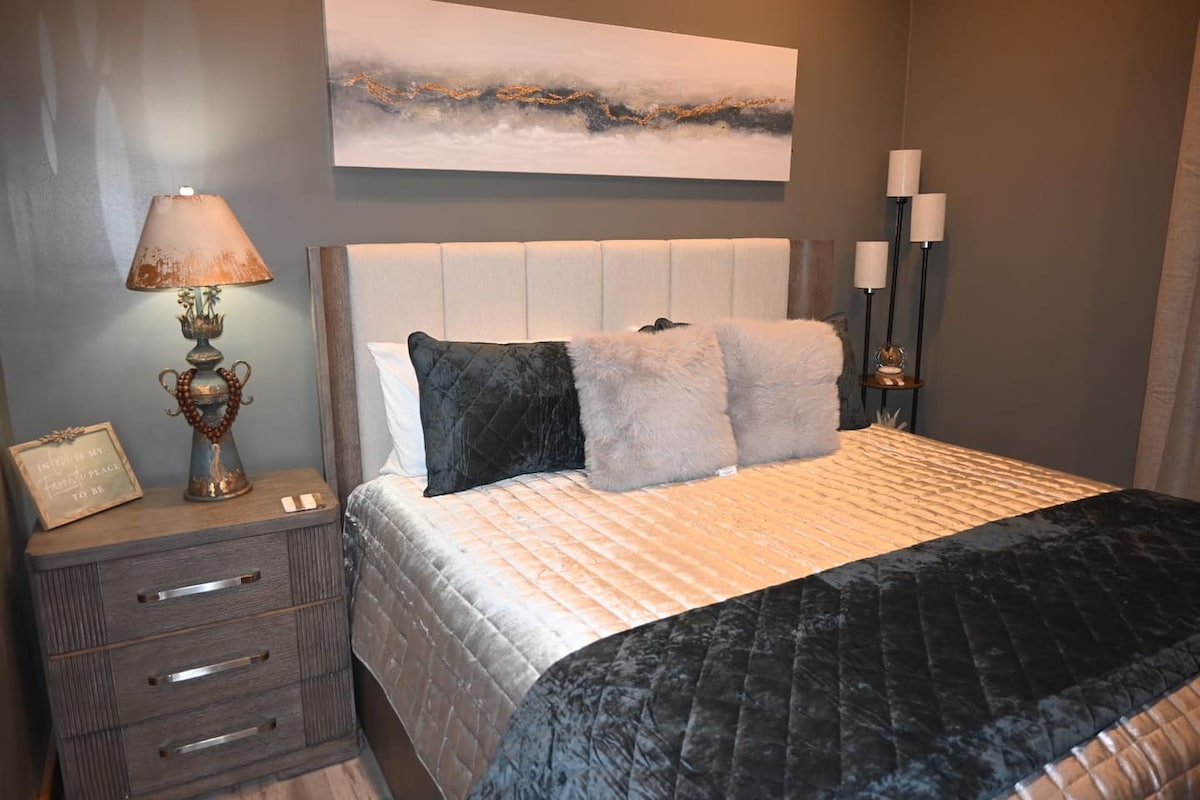 El dormitorio dos ofrece un refugio cómodo y relajante, con una lujosa cama tamaño king y una acogedora chimenea eléctrica que añade calidez y ambiente. Cuidadosamente amueblado para descansar y relajarse, este espacio proporciona el lugar perfecto para relajarse.