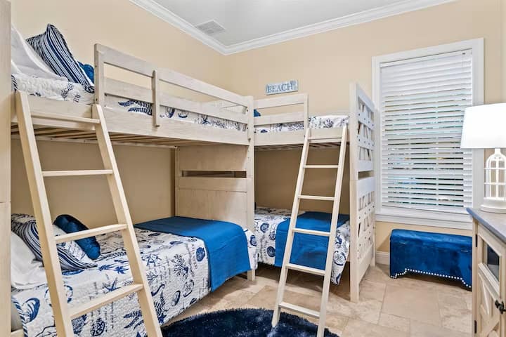 Una habitación con literas que a los niños les encanta 
Dos juegos de literas acogedoras, decoración costera y mucho espacio para quedarse a dormir, reír y recargar energías después de grandes días de playa.