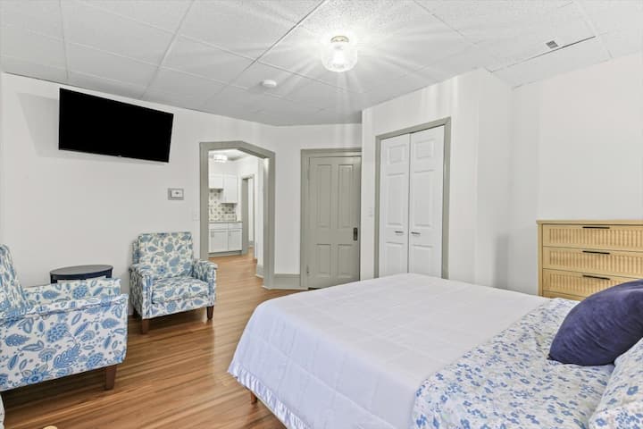 Dormitorio con asientos y televisor inteligente de 55"