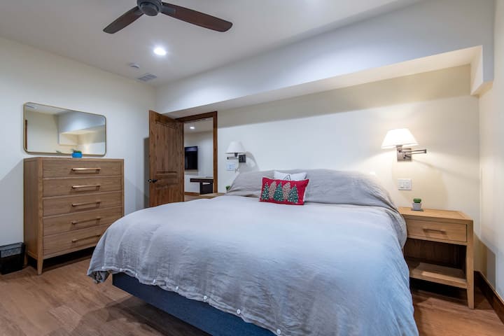 Second king bedroom with nightstands, dresser, and lighting.