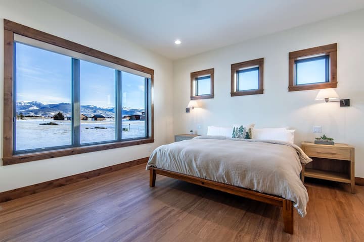 Primary king suite with sweeping Teton views and natural light.