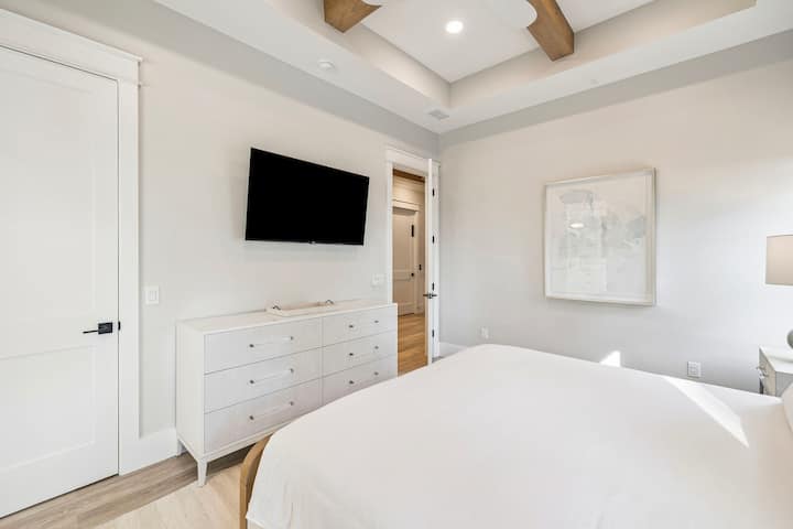 Disfrute de un sueño reparador en su elegante dormitorio, que cuenta con sábanas blancas y frescas, vigas de techo a la vista y comodidades modernas para ofrecerle la máxima comodidad.