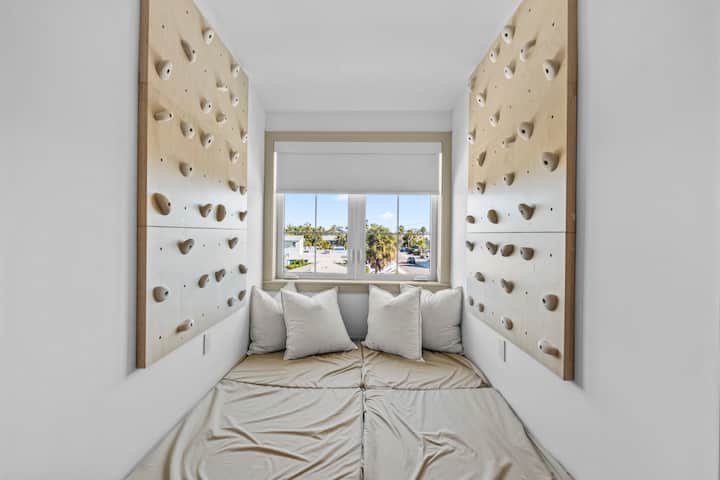 Tercer dormitorio, rincón para dormir con una creativa pared de escalada