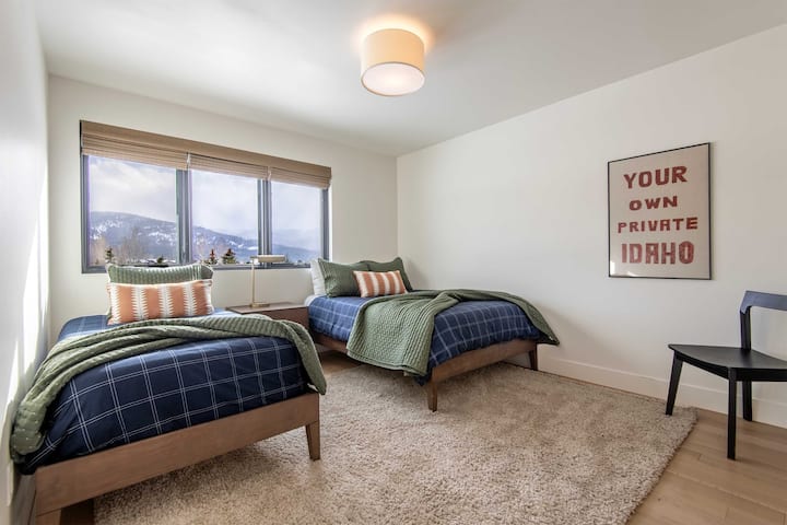 Bedroom with cozy plaid bedding and a nod to Idaho pride — a warm, personality-filled space that perfectly captures the spirit of this Teton retreat.