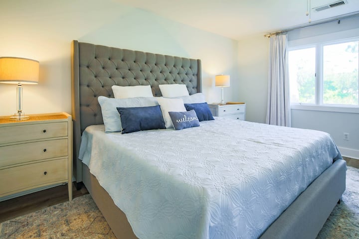 The primary suite features a king bed and night stands with reading lamps.