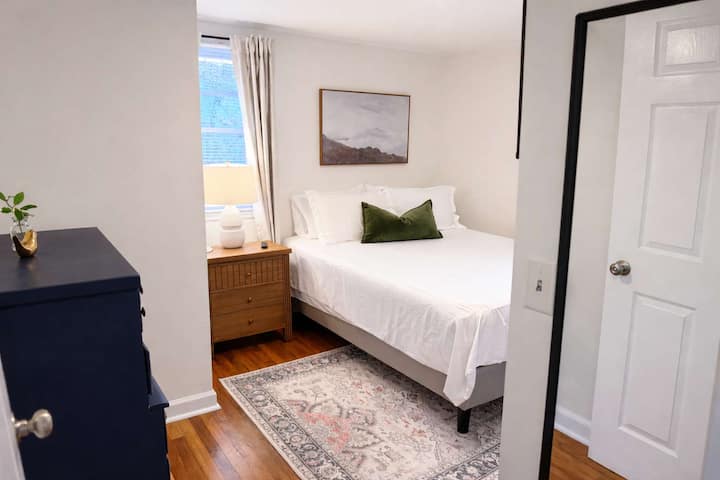Queen bedroom with clothing storage and smart Vizio TV