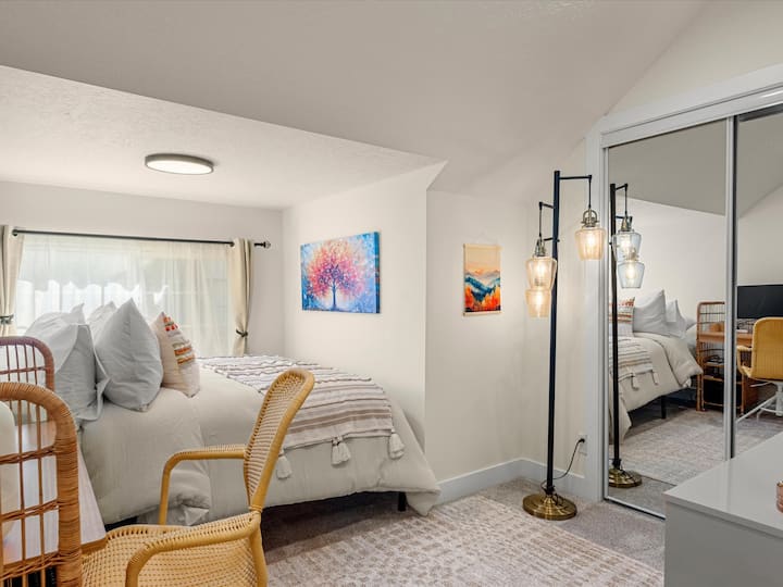 Cozy bedroom with workstation and TV