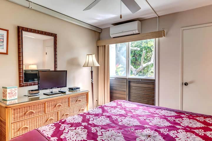 NAP-B43 This bright master suite boasts a king bed, large windows with garden views, and tropical decor to match your Hawaiian getaway.