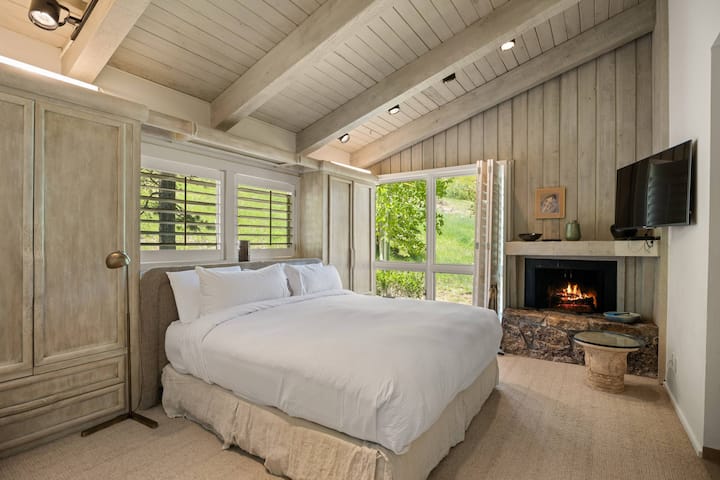The master suite features a king bed, wood burning fireplace, flat screen TV and newly remodeled en-suite bath.