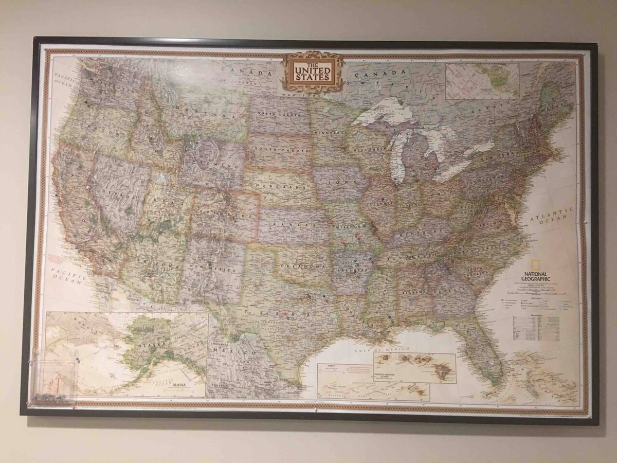 A detailed map of the United States is displayed on the wall. The map features intricate geographical outlines, city names, and major landmarks. Various colors indicate different states and terrains, contributing to a comprehensive view of the country. A decorative title at the top reads 'United States.'