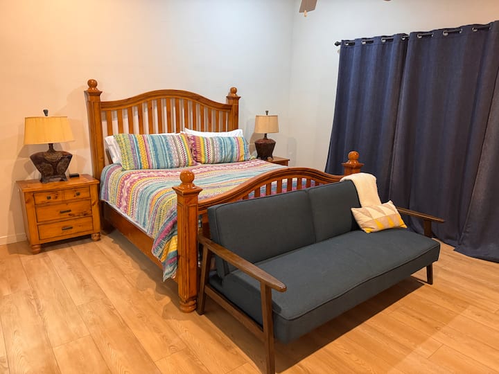 ห้องพักขนาดคิงไซส์ที่อบอุ่นพร้อมเครื่องนอนหลากสี โซฟาและผ้าม่านทึบแสง