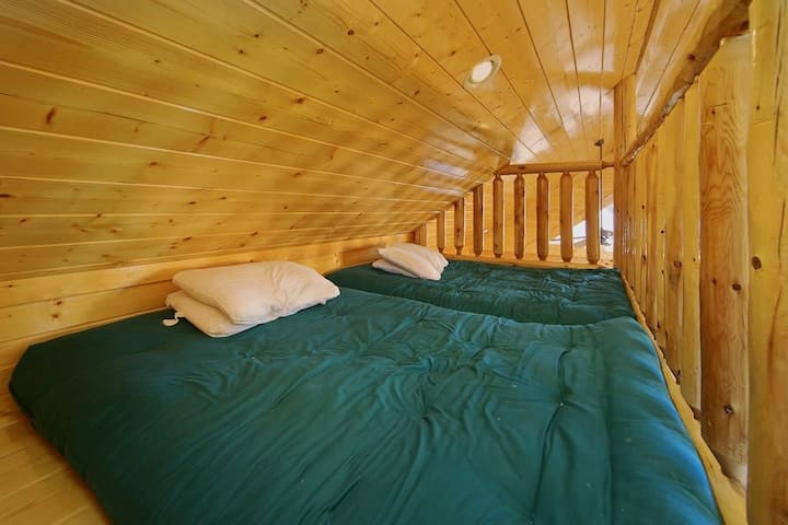 - Loft sleeping area with twin beds under warm wood ceilings   - Perfect hideaway for kids or extra guests in cozy comfort   - A snug mountain nook that captures the charm of cabin living
