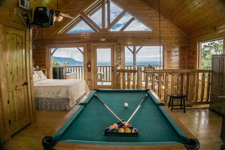 - Open loft bedroom with pool table and full mountain views   - Floor-to-ceiling windows fill the space with natural light   - A unique space where fun and relaxation meet in one retreat