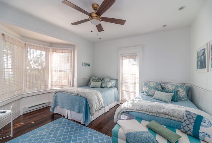 Two full beds, ceiling fan and door out to the side patio.