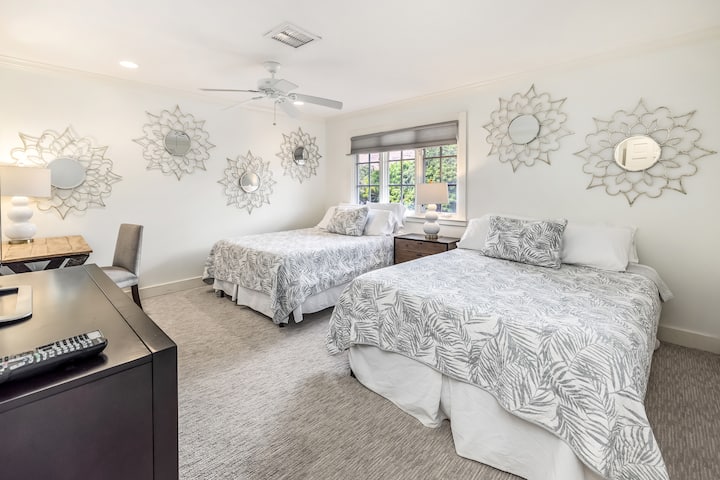 Bright Guest Bedroom 3 with two queen beds, mountain views, and a private ensuite.