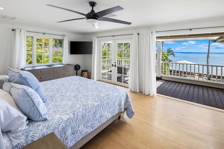 Primary Bedroom 1 — king bed, ensuite bath, and sweeping ocean views.