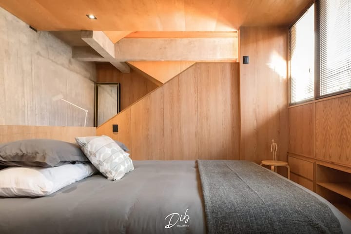 Comfortable bedding and warm wood tones throughout—both bedrooms get the same thoughtful design treatment.