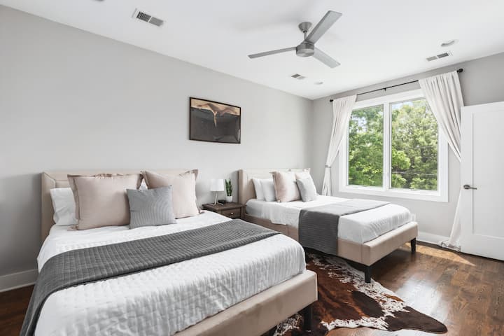 Upstairs bedroom with 2 queen beds, luxury linens, a closet, and a connecting bathroom.