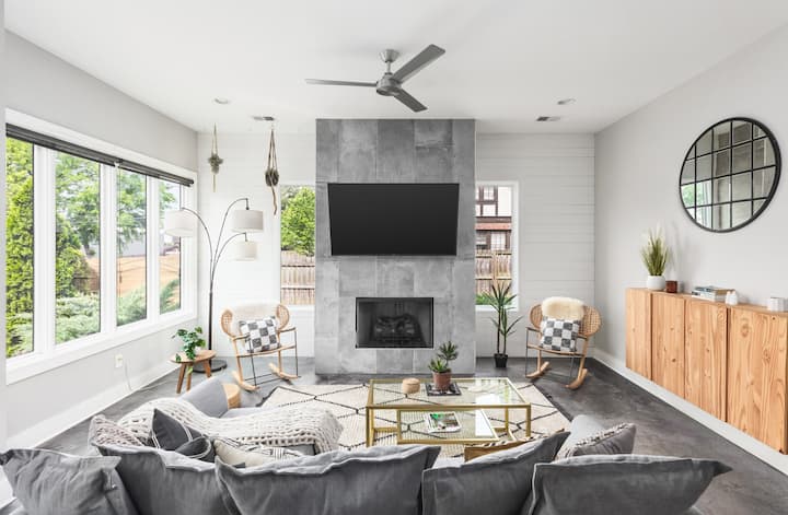 Cozy living room with a Smart TV, Queen sleep sofa, lots of natural light, custom blinds, direct access to the private fenced in yard, and plenty of seating.