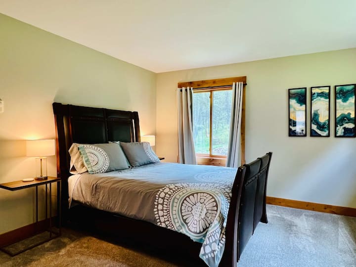 Main floor bedroom with queen bed and ensuite bathroom