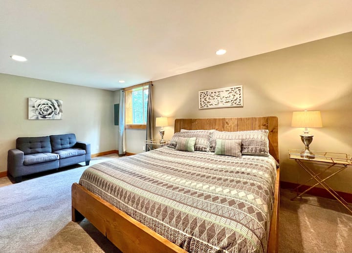 Downstairs bedroom with king bed, and sitting are with full size sofa bed and tv