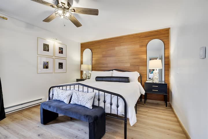 Bedroom 1 - Includes a king-size bed, Smart TV, and a cozy seating area. Conveniently located next to the bathroom with entry from the first-floor living room.