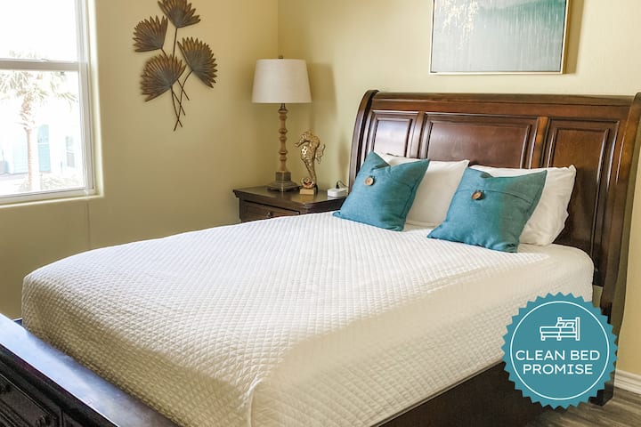 Sink into comfort with crisp white linens and cheerful yellow walls that brighten your mornings. Your peaceful retreat awaits.