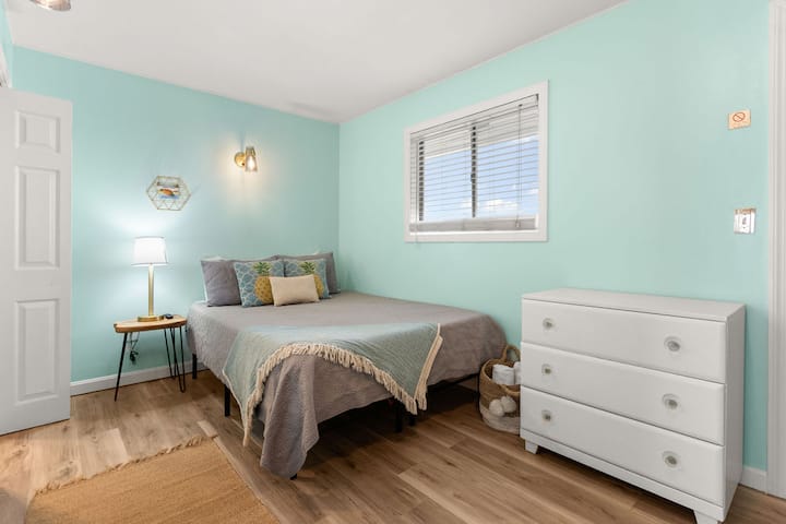 Bedroom with queen bed and flat screen smart TV