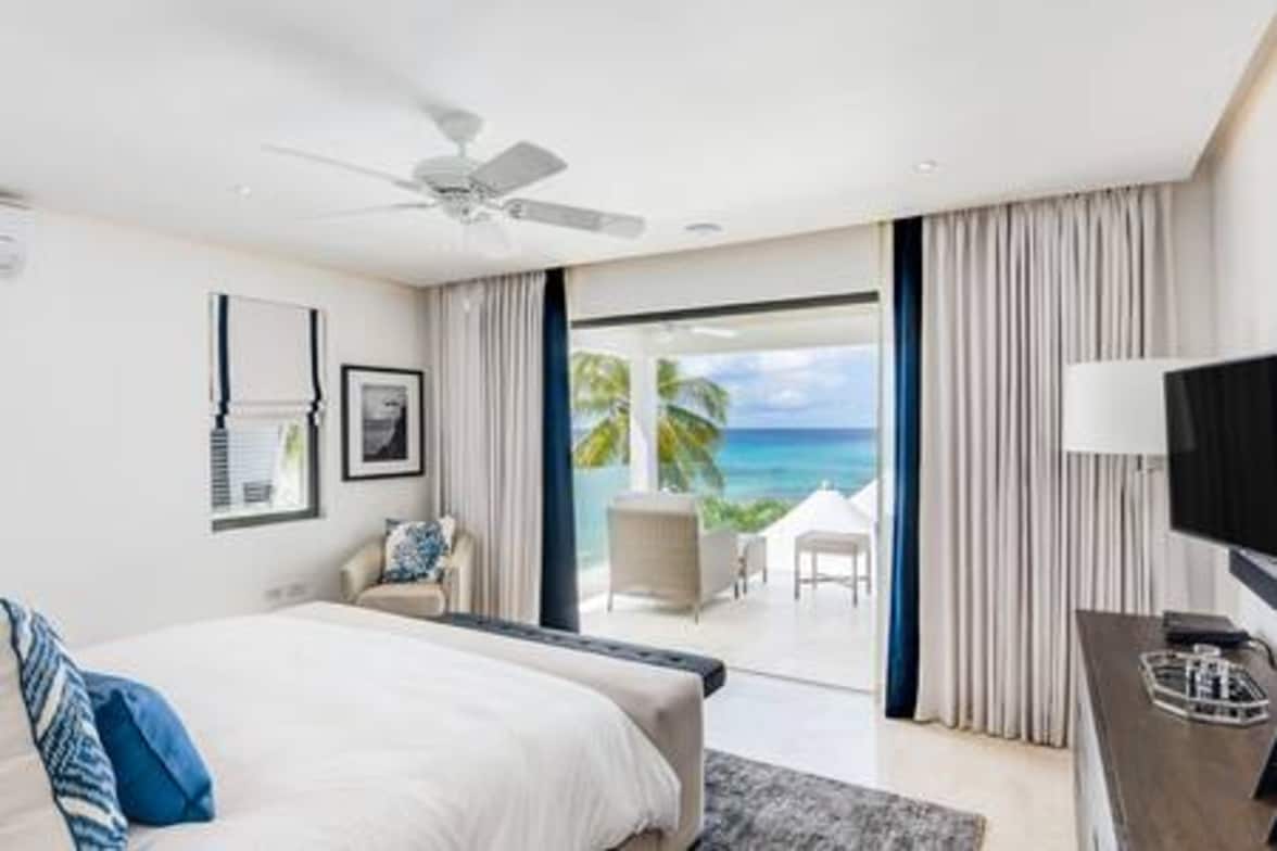 Master bedroom with a king size bed (US), ensuite bathroom, TV, security safe, air conditioning, bath robes, hair dryer and a balcony with sea views.