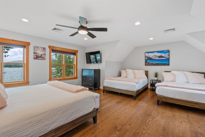 Second floor guest bedroom with king and two queen beds, the bath for this bedroom is a few steps down the hall