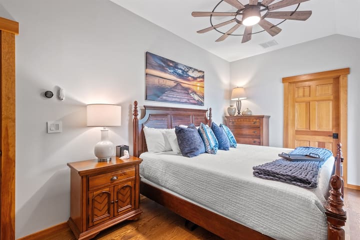 Second floor ensuite bedroom with king bed, balcony overlooking lake and its own full bath