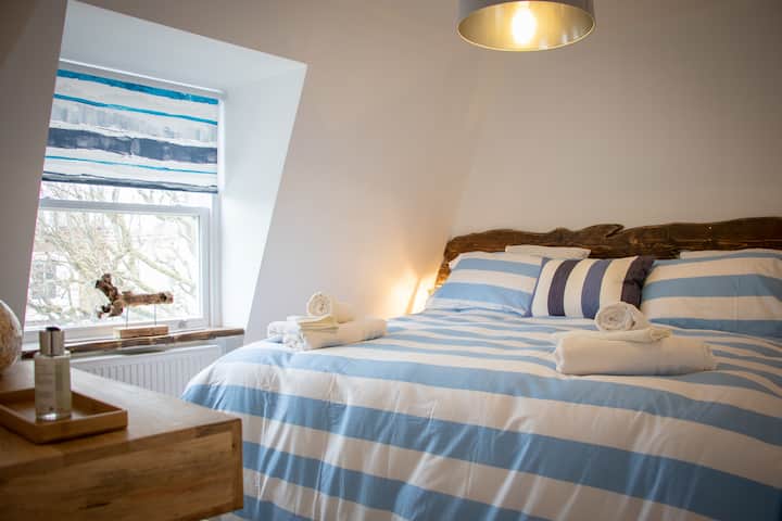 The Beach House Driftwood apartment
חדר שינה עם מיטת קינג סייז או שתי מיטות יחיד
