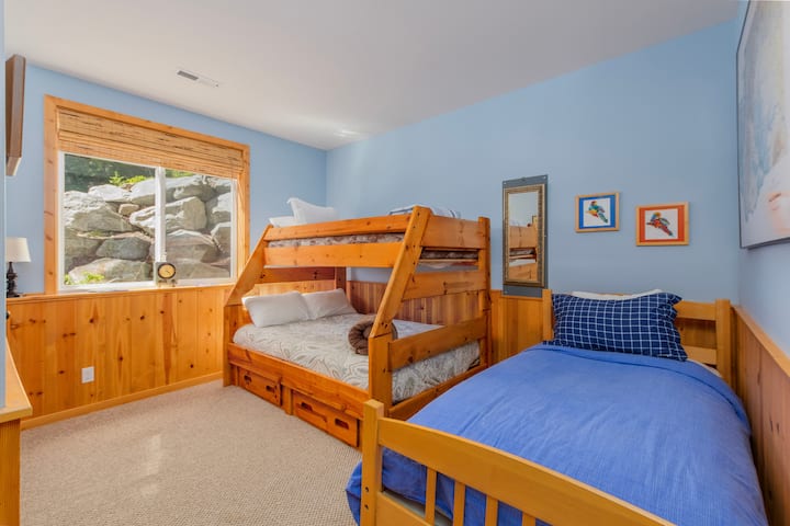 Lower level bedroom with twin over full bunk and twin bed