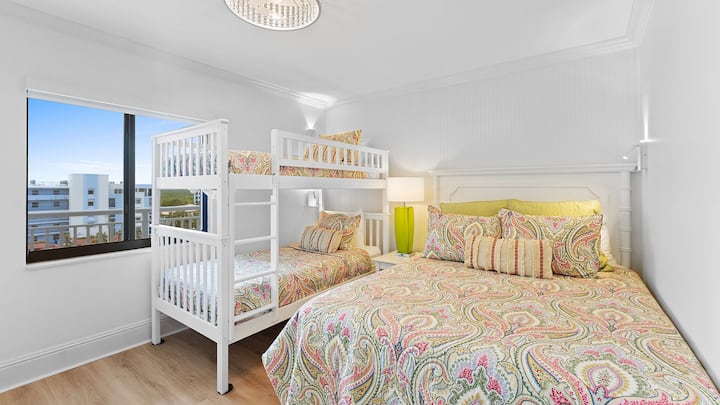 The guest bedroom queen bed and twin bunk provide comfortable sleeping arrangements for family and friends. Each bed has a wall mounted reading light with a convenient charging station