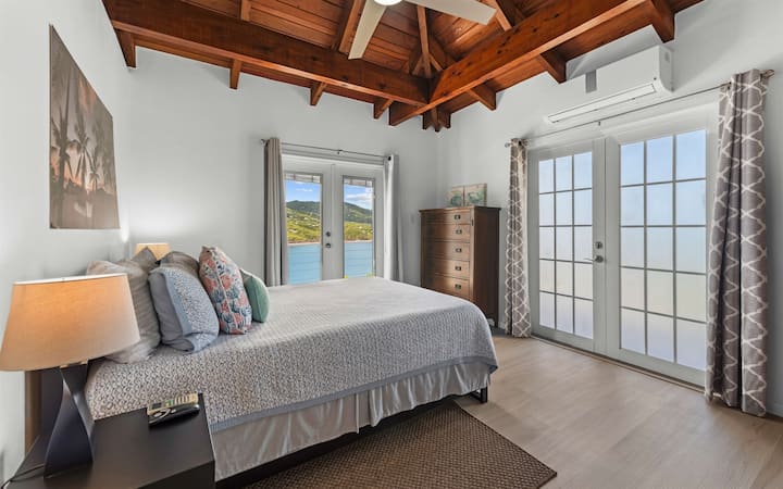 חדר שינה עם מיטת קווין סייז, חדר שינה שני בקומה הראשית עם נוף מדהים למפרץ מגן.
