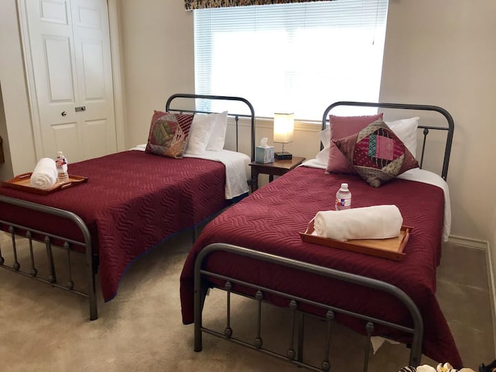 The final bedroom consists of two twin beds and a rocking chair.