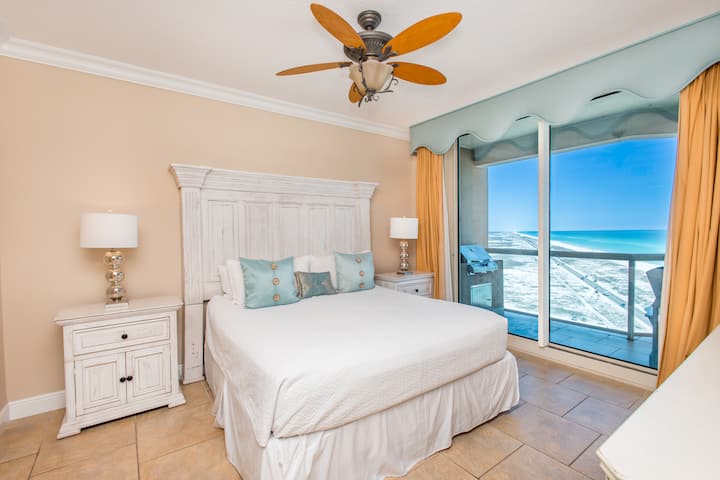 Wake up to the soft ocean breeze and endless blue stretching beyond your balcony—this bright, coastal bedroom invites you to unwind in pure beachfront serenity.
