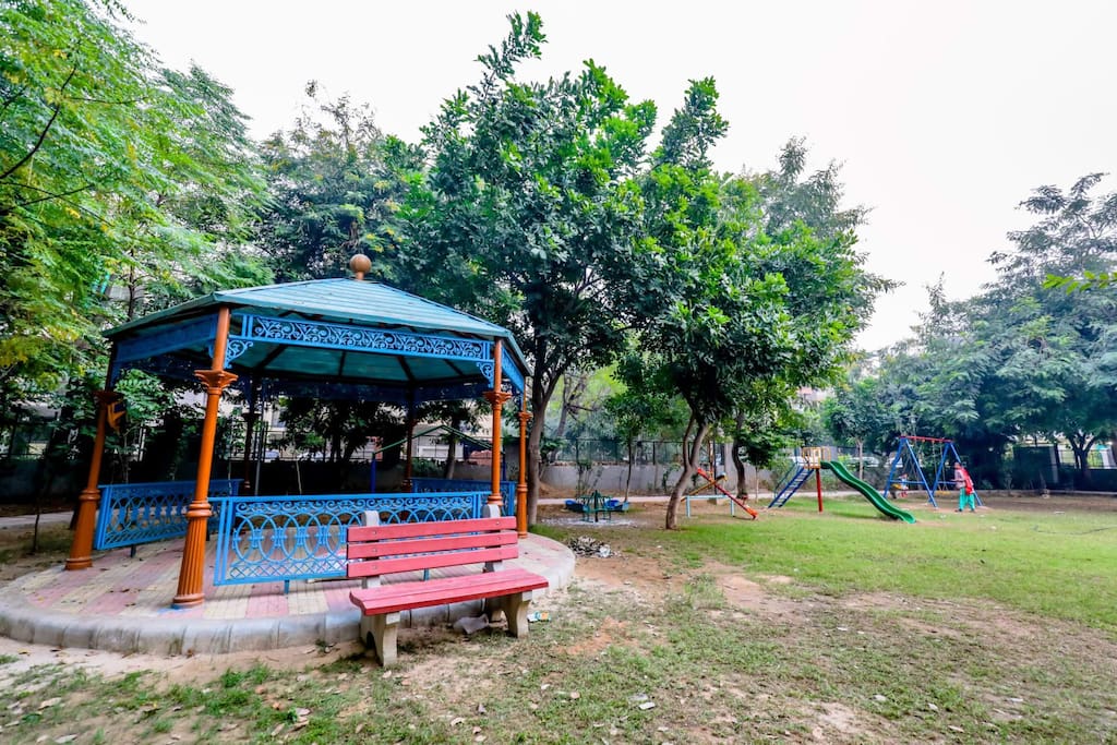 A picturesque view of the park, with lush greenery, walking paths, and a serene natural setting
