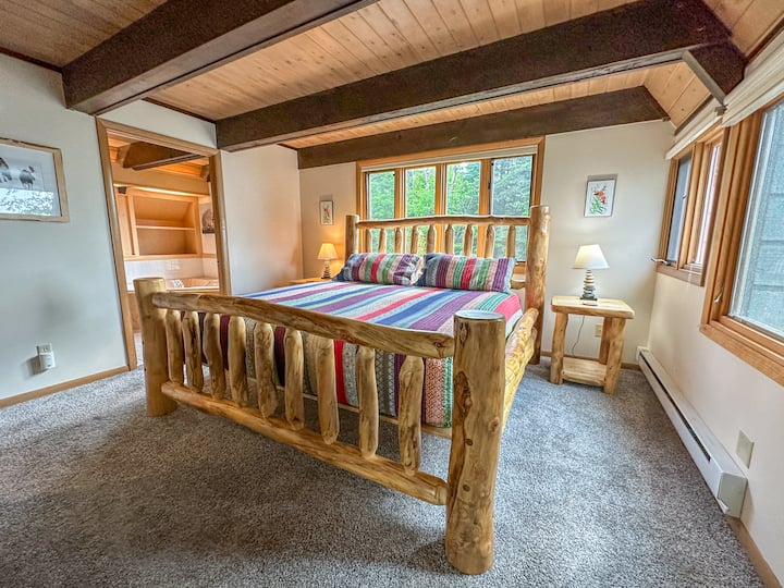 Bedroom 1 features a beautiful custom kind sized bed.