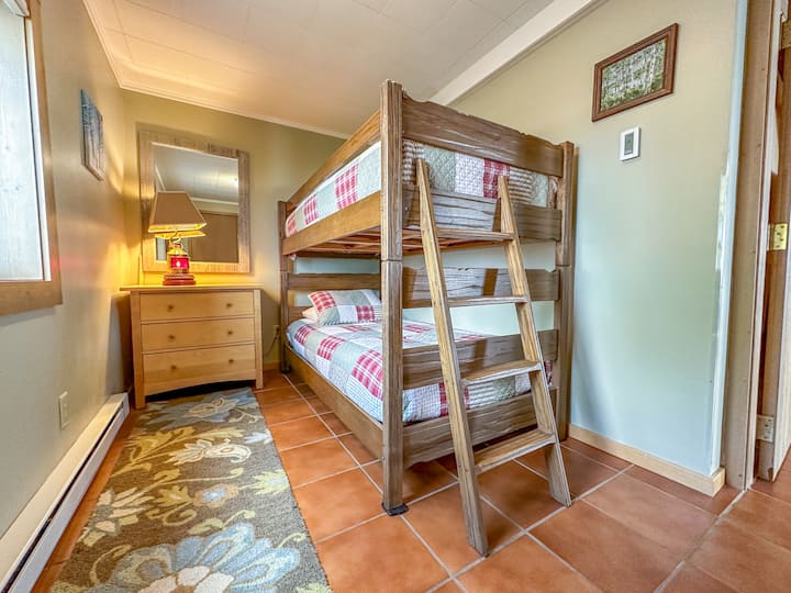 The fourth bedroom, this one located on the lower level has twin over twin bunk beds.