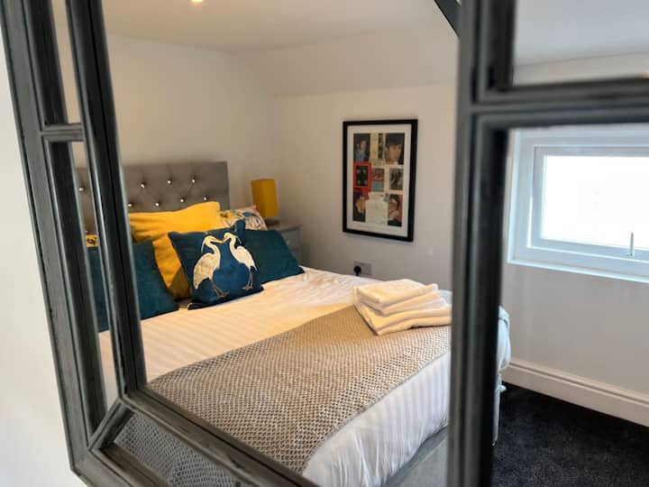 Freshly made double bed lower floor.