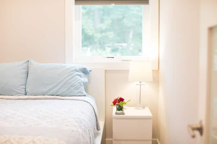 Queen Bedroom 1- Tranquil queen suite with soft linens and natural light.