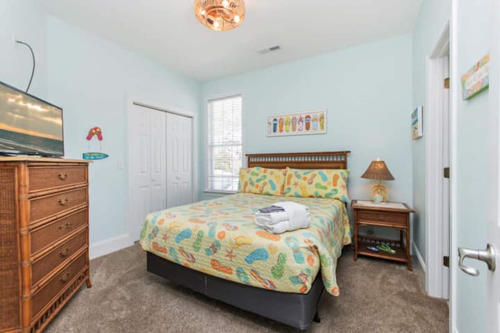 Джапанки и сладки сънища! Тази спалня на последния етаж разполага с уютно двойно легло, игрив крайбрежен декор и телевизор за разпускане след цял ден слънце и сърф.