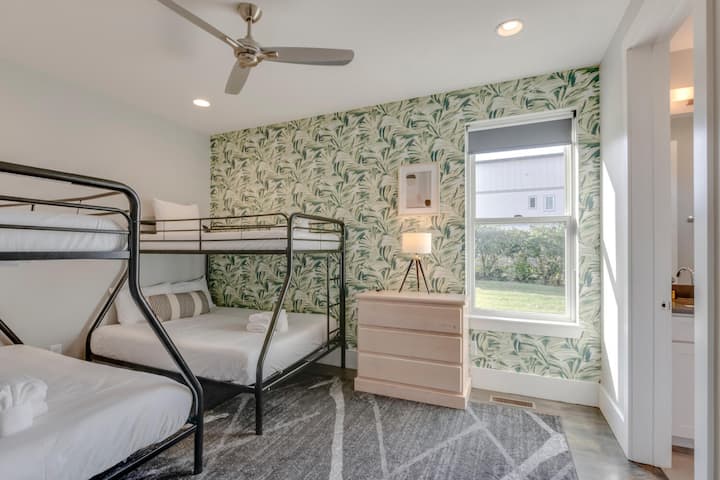 Room with bunk beds and vibrant wallpaper.