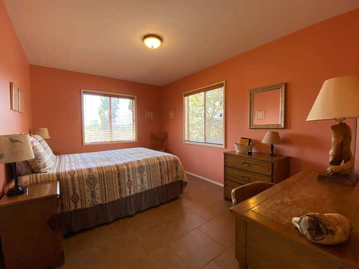First room on the right - Queen bed with plenty of light and a desk, bureau, side tables and closet for your things.