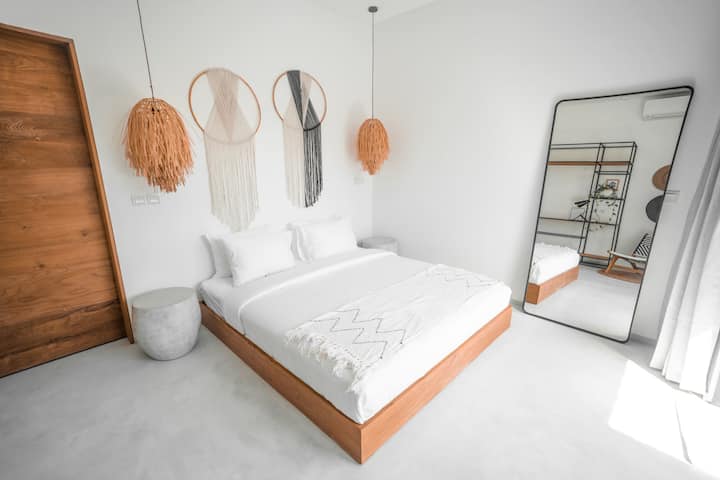 Poolside bedroom with kind size bed, reading nook, high speed internet and private en-suite bathroom.