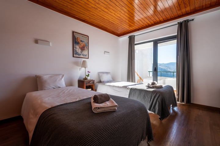 Cozy lake-view room with twin beds and a balcony for breathtaking vistas.