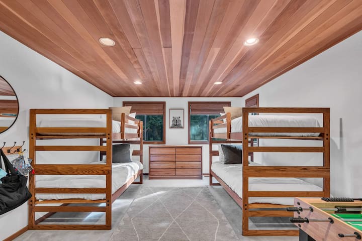 Bedroom 3 (lower floor): Two twin bunk beds, dresser, foosball table